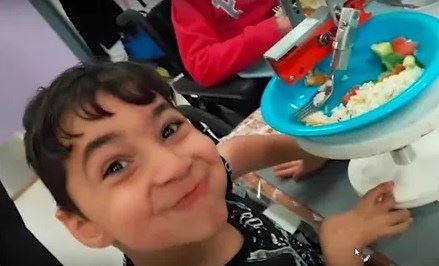 "Watch the grin as Yusuf, 8, feeds himself for first time"